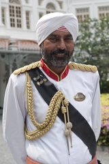 The Raffles doorman welcomes guests with a smile