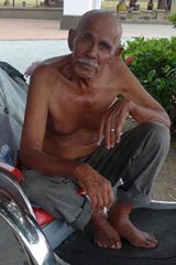 A rickshaw driver takes a rest