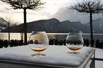 Brandy glasses sitting on a bed of snow.